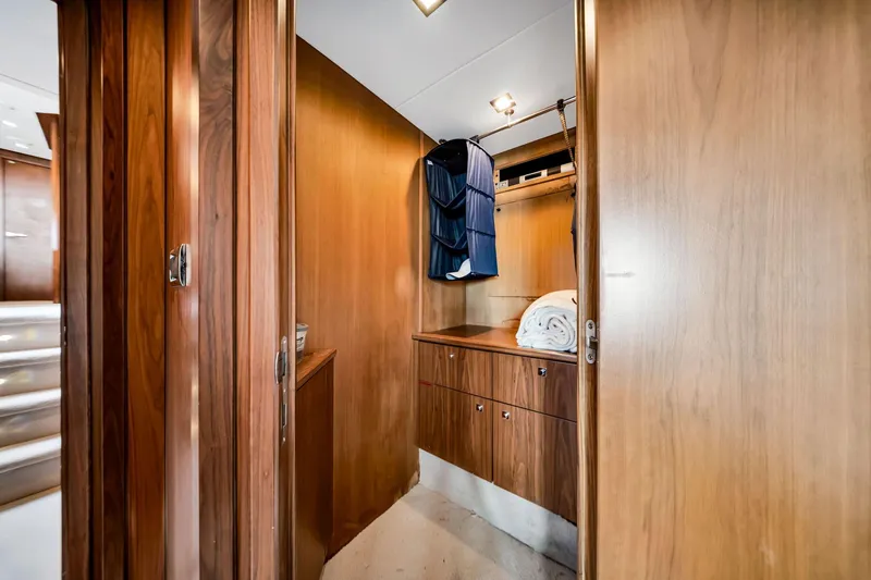 Slide: The Image of Interior of 2012 Sunseeker 74 Sport Yacht with wooden cabinetry and hanging clothes. - 32