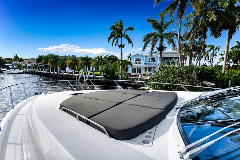 Slide: The Image of Sunseeker 74 Sport Yacht 2012 on a scenic waterfront with palm trees and luxury homes. - 46