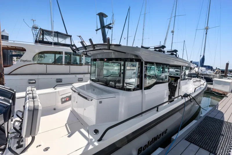 The Image of 2021 Axopar 37 XC BRABUS Trim Wet Bar docked at marina, showcasing sleek design. - 0