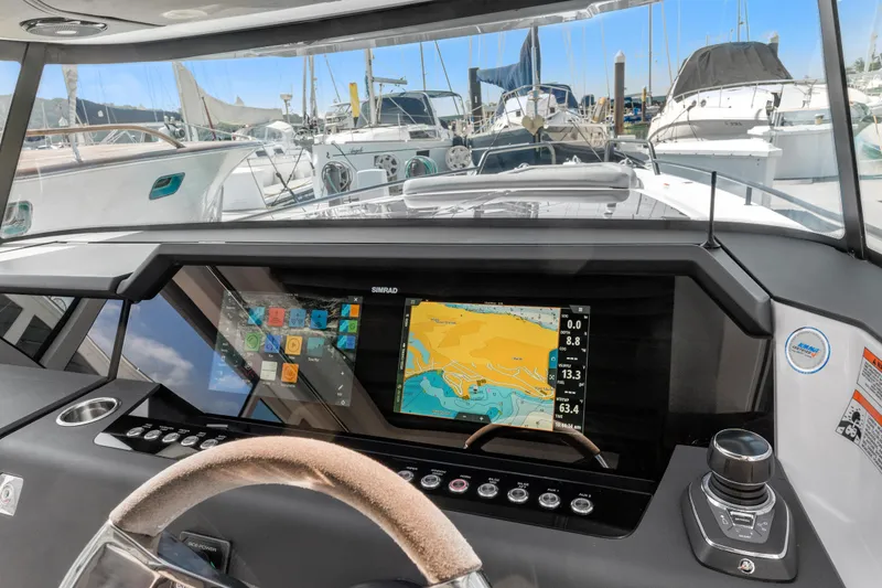 Slide: The Image of Helm of 2021 Axopar 37 XC BRABUS with navigation display, docked among yachts. - 14