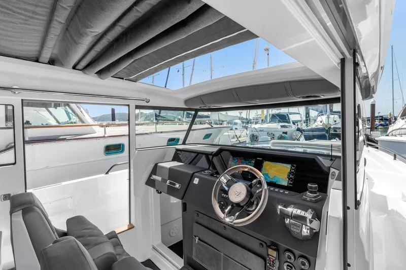 Slide: The Image of Interior of 2021 Axopar 37 XC BRABUS Trim Wet Bar, featuring modern helm and navigation displays. - 15
