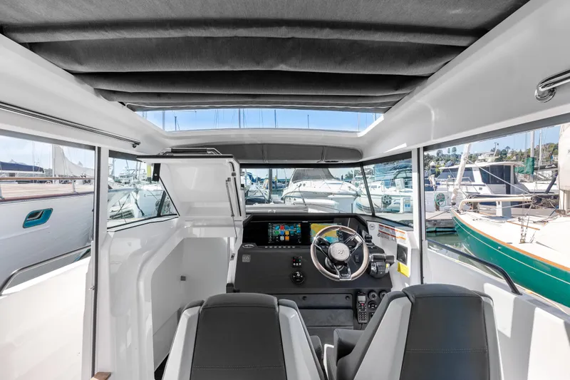 Slide: The Image of Interior view of 2021 Axopar 37 XC BRABUS Trim Wet Bar, featuring modern helm and seating. - 16