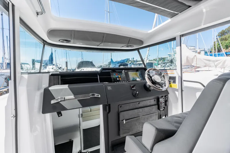 Slide: The Image of Interior of 2021 Axopar 37 XC BRABUS Trim Wet Bar, featuring modern helm and controls. - 17