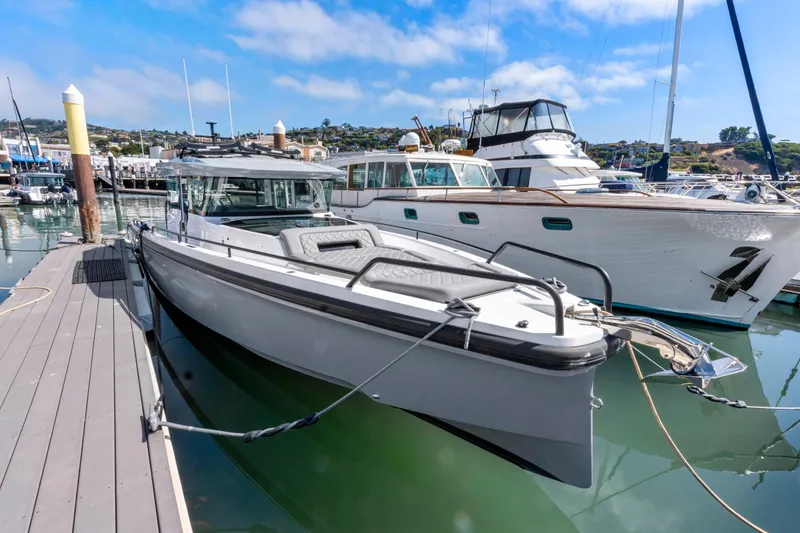 Slide: The Image of 2021 Axopar 37 XC BRABUS Trim Wet Bar docked at marina. - 2