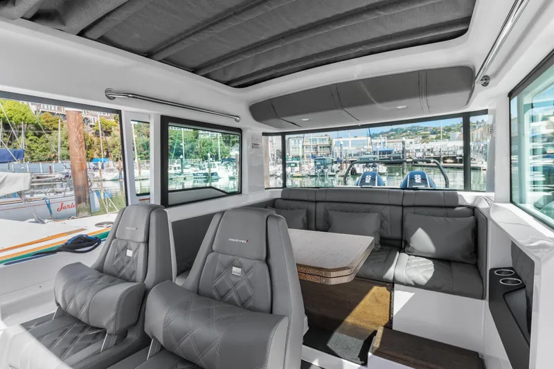 Slide: The Image of Interior of 2021 Axopar 37 XC BRABUS Trim Wet Bar, featuring luxurious seating and marina view. - 21