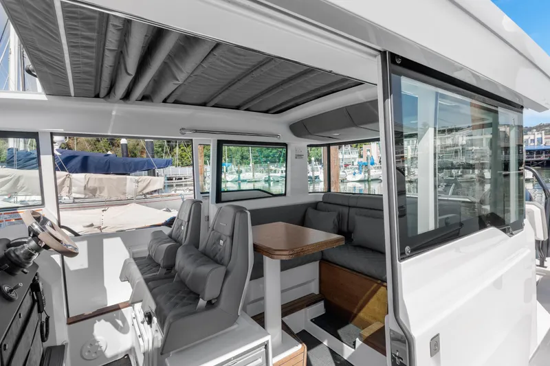 Slide: The Image of 2021 Axopar 37 XC BRABUS Trim Wet Bar interior with seating and table. - 25