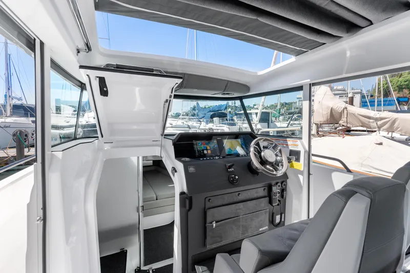 Slide: The Image of Interior of 2021 Axopar 37 XC BRABUS Trim Wet Bar, featuring modern helm and seating. - 27
