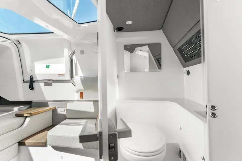 Slide: The Image of Interior of 2021 Axopar 37 XC BRABUS Trim Wet Bar, featuring seating and a compact bathroom. - 30