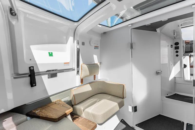 Slide: The Image of 2021 Axopar 37 XC BRABUS interior with seating and wet bar, featuring modern design elements. - 33