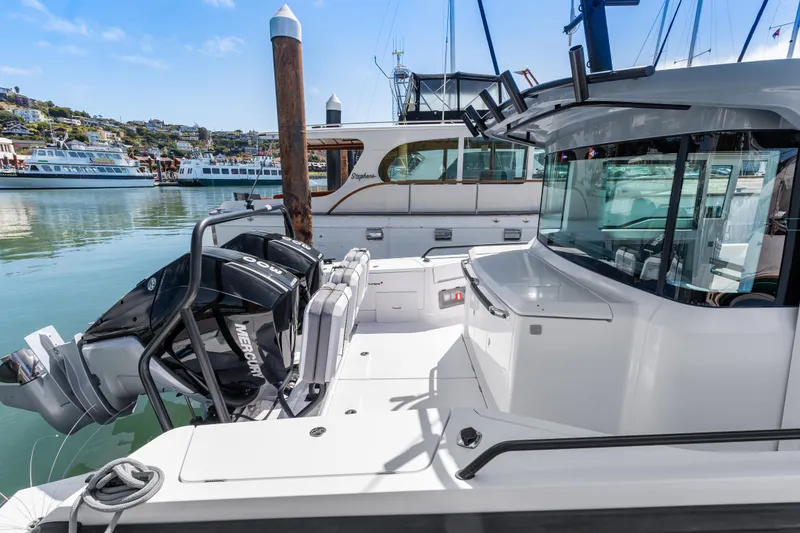 Slide: The Image of 2021 Axopar 37 XC BRABUS Trim Wet Bar docked, featuring dual Mercury engines. - 4