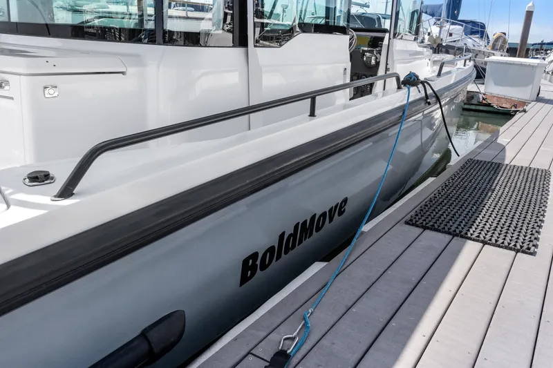 Slide: The Image of 2021 Axopar 37 XC BRABUS Trim Wet Bar docked, featuring sleek design and "BoldMove" branding. - 7