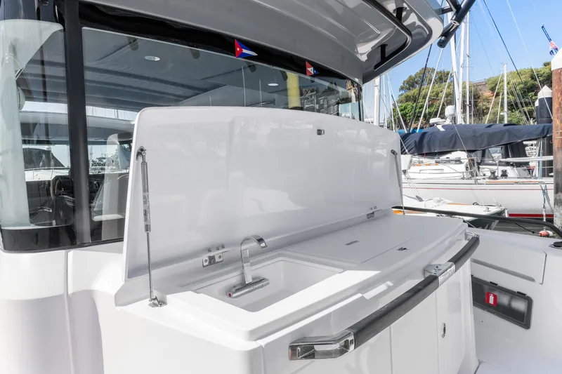 Slide: The Image of 2021 Axopar 37 XC BRABUS Trim Wet Bar, sleek design, docked at marina. - 8