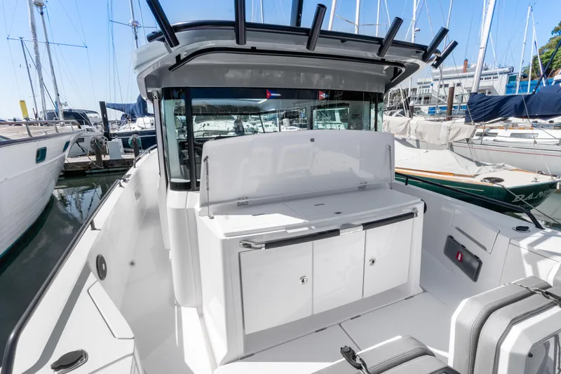 Slide: The Image of 2021 Axopar 37 XC BRABUS Trim Wet Bar, docked in a marina, showcasing sleek design. - 9