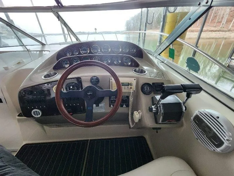 Slide: The Image of Cockpit of 2000 Rinker 340 Fiesta Vee boat with steering wheel and control panel. - 15