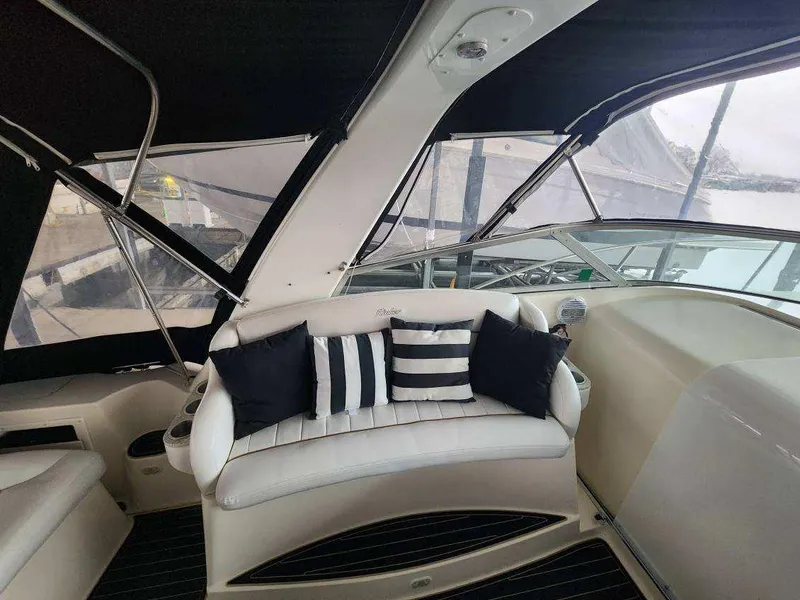 Slide: The Image of Interior of 2000 Rinker 340 Fiesta Vee yacht with striped cushions and sleek design. - 20