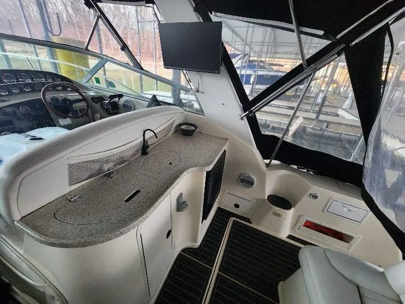 Slide: The Image of Interior of a 2000 Rinker 340 Fiesta Vee boat with helm and kitchenette. - 21