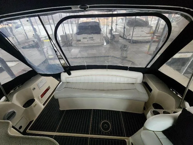 Slide: The Image of Interior of a 2000 Rinker 340 Fiesta Vee boat with white seating and black flooring. - 22