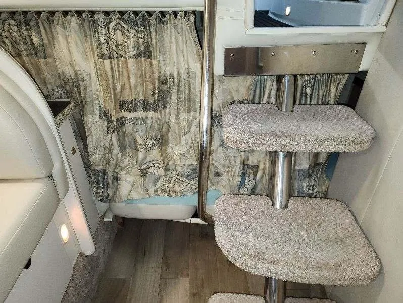 Slide: The Image of Interior of 2000 Rinker 340 Fiesta Vee with carpeted steps and patterned curtains. - 26