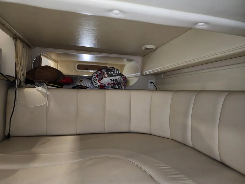 Slide: The Image of Interior cabin of 2000 Rinker 340 Fiesta Vee boat with beige seating. - 28