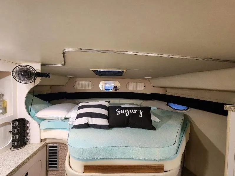 Slide: The Image of Cozy cabin interior of 2000 Rinker 340 Fiesta Vee with bed and decorative pillows. - 30