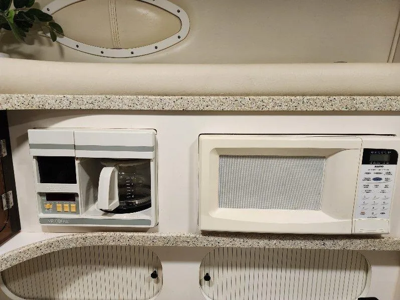Slide: The Image of Kitchen area of a 2000 Rinker 340 Fiesta Vee with coffee maker and microwave. - 35