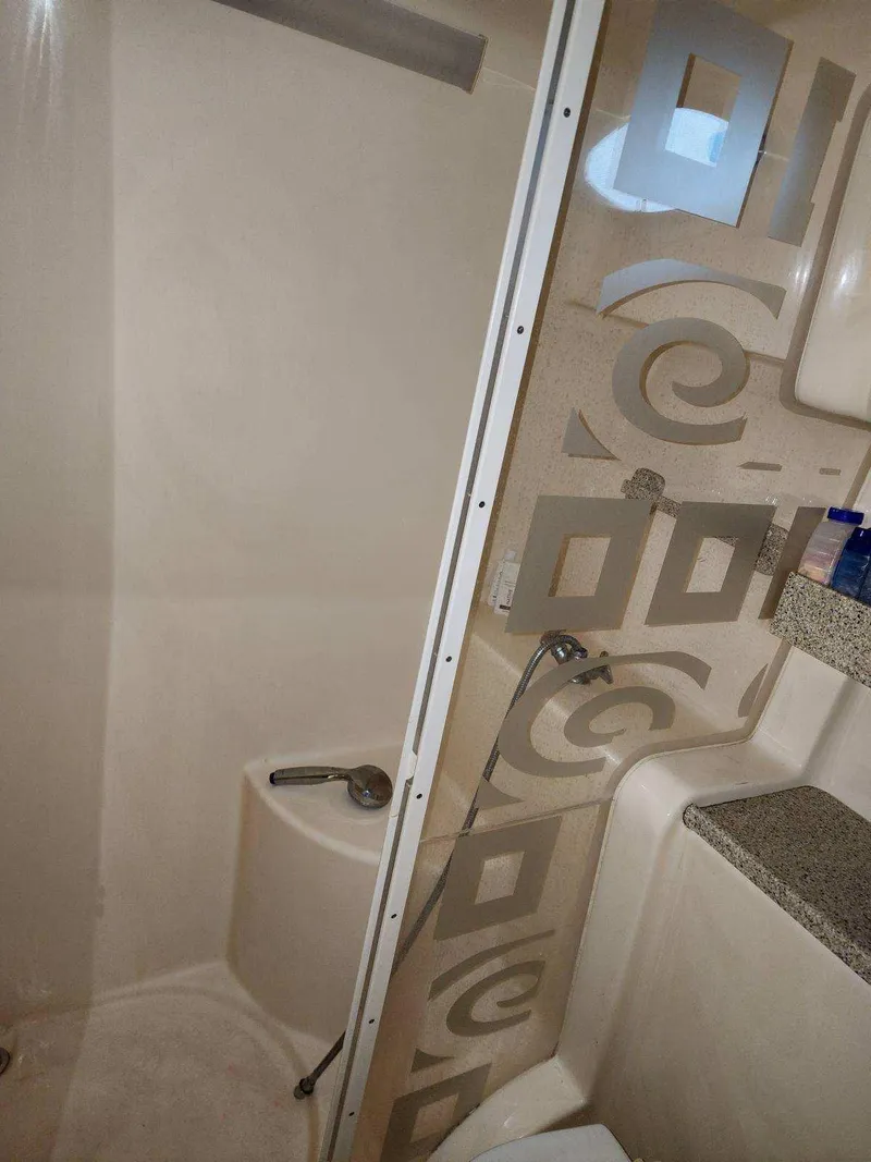 Slide: The Image of Bathroom interior of 2000 Rinker 340 Fiesta Vee boat with decorative shower panel. - 36