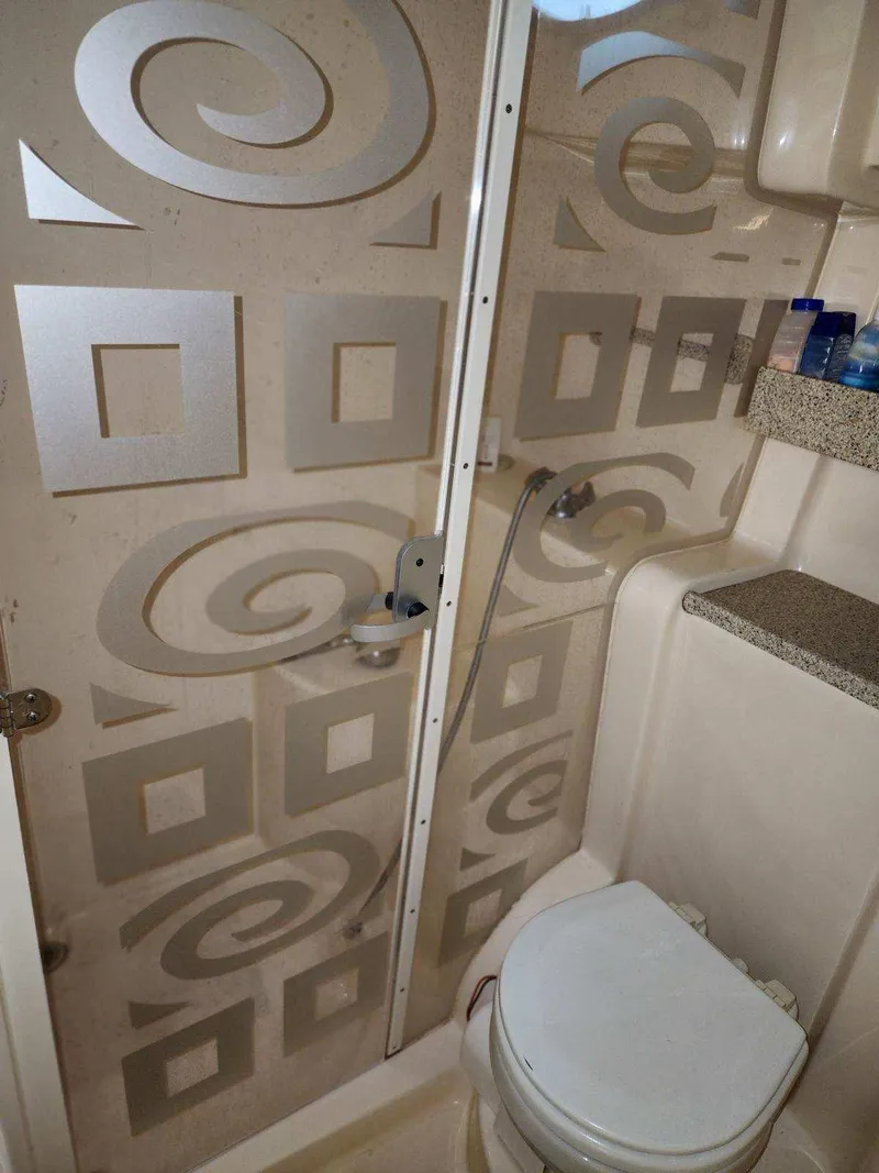 Slide: The Image of Bathroom interior of 2000 Rinker 340 Fiesta Vee boat with patterned shower door. - 37