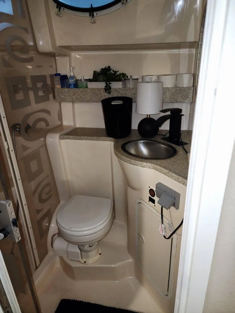 Slide: The Image of Compact bathroom in a 2000 Rinker 340 Fiesta Vee boat with sink and toilet. - 38