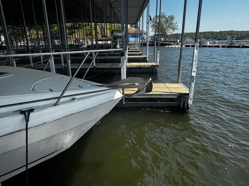 Slide: The Image of 2000 Rinker 340 Fiesta Vee docked at marina, calm water, sunny day. - 5
