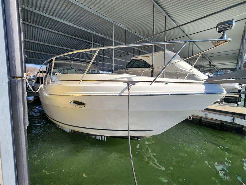 Slide: The Image of 2000 Rinker 340 Fiesta Vee boat docked in a covered marina. - 7