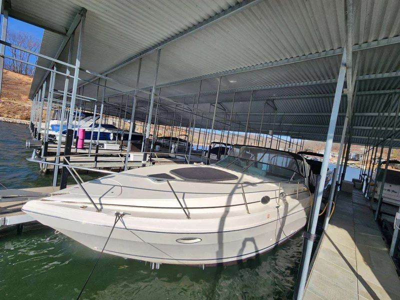 Slide: The Image of 2000 Rinker 340 Fiesta Vee docked in a covered marina. - 9