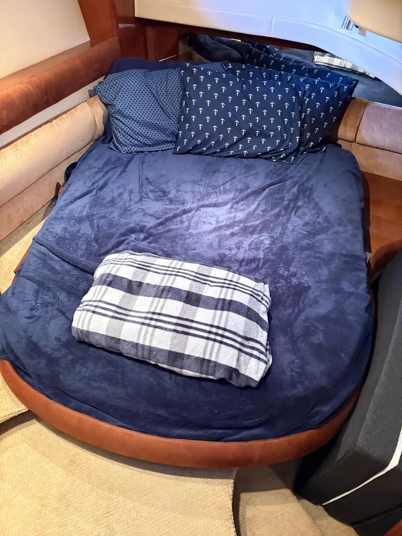 Slide: The Image of Cozy bed in 2006 Meridian Fly Bridge Convertible yacht cabin with blue bedding. - 21