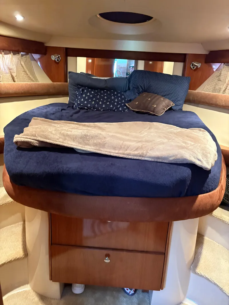 Slide: The Image of Luxurious 2006 Meridian Fly Bridge Convertible cabin with cozy bedding and elegant wood finish. - 22