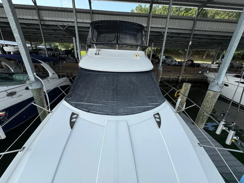 Slide: The Image of 2006 Meridian Fly Bridge Convertible yacht docked under a covered marina. - 3