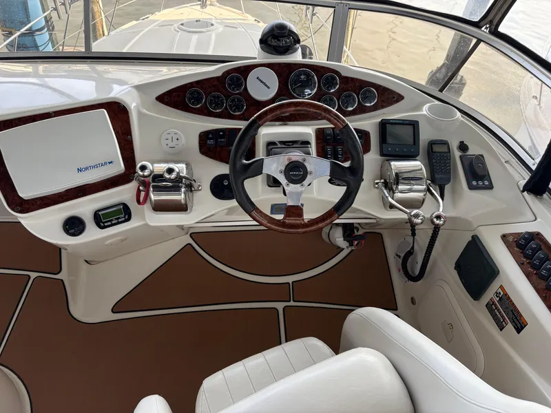 Slide: The Image of 2006 Meridian Fly Bridge Convertible helm with steering wheel, controls, and navigation equipment. - 7