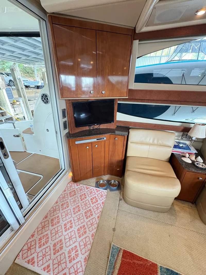 Slide: The Image of Interior of 2006 Meridian Fly Bridge Convertible with TV, chair, and wooden cabinets. - 17