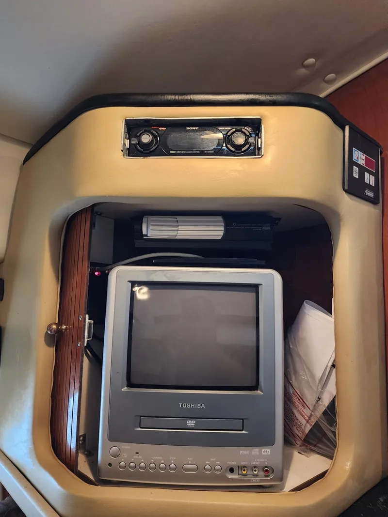 Slide: The Image of 2003 Rinker 270 Express Cruiser interior with Toshiba TV and Sony stereo system. - 30