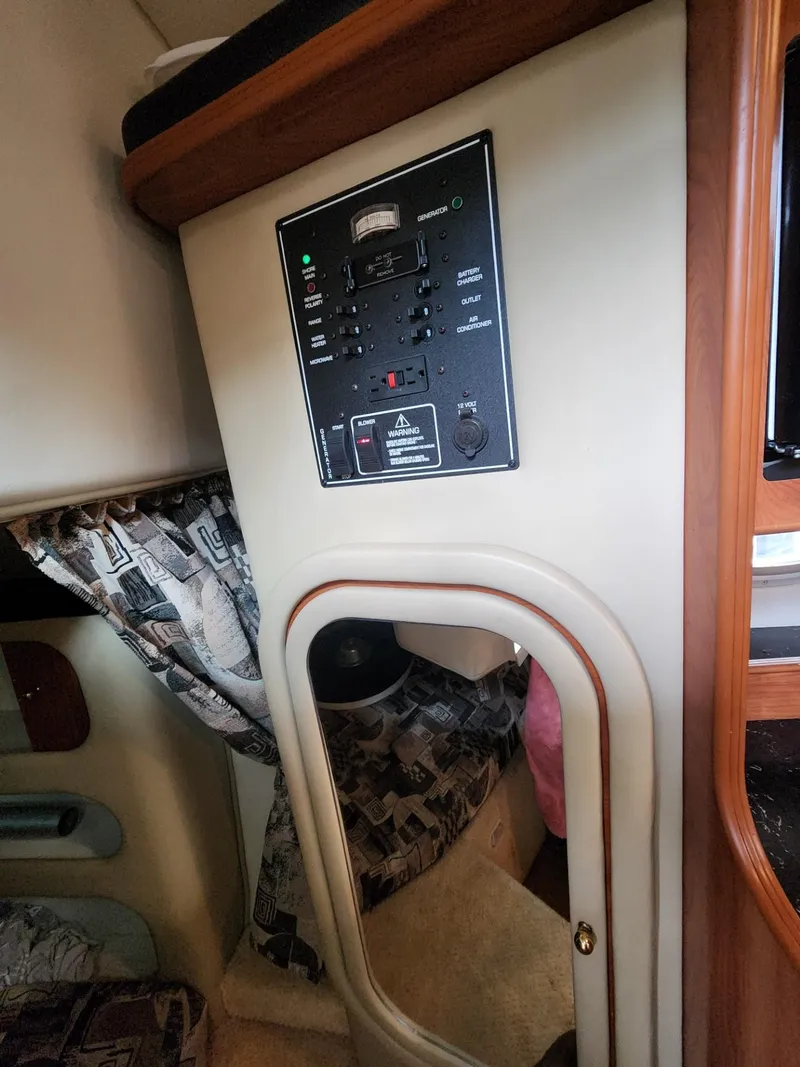 Slide: The Image of 2003 Rinker 270 Express Cruiser interior with control panel and cabin details. - 32
