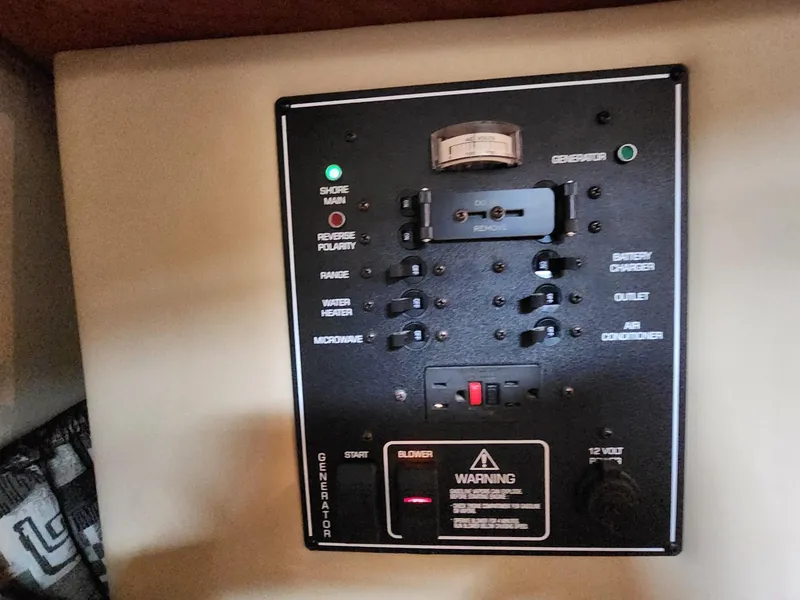 Slide: The Image of Control panel of a 2003 Rinker 270 Express Cruiser, featuring various switches and indicators. - 33
