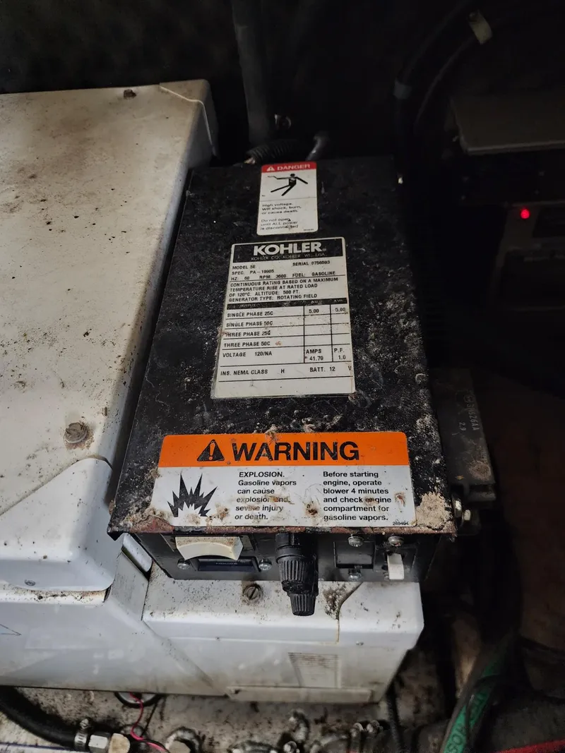 Slide: The Image of Kohler generator with warning label in a 2003 Rinker 270 Express Cruiser engine compartment. - 36