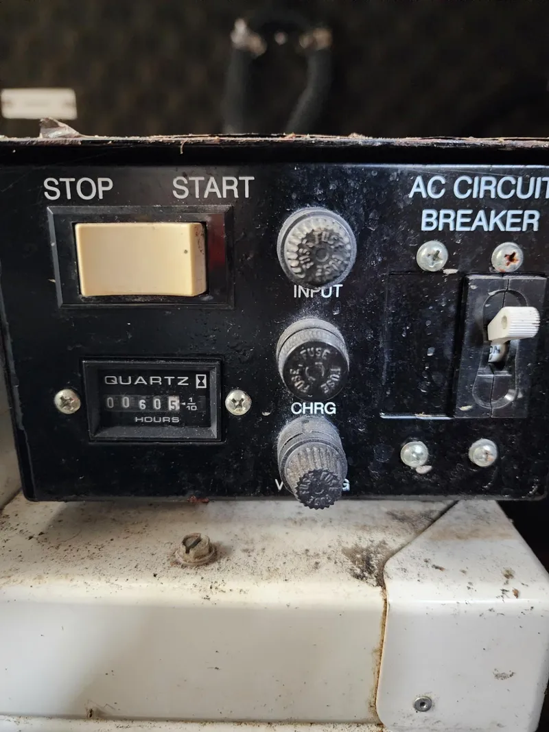 Slide: The Image of Control panel of a 2003 Rinker 270 Express Cruiser with hour meter and circuit breaker. - 37