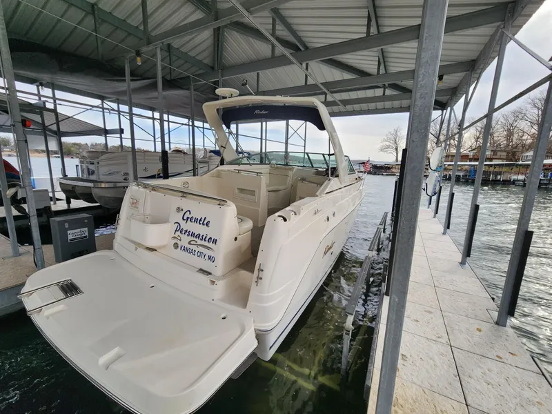Slide: The Image of 2003 Rinker 270 Express Cruiser docked in a covered marina. - 4