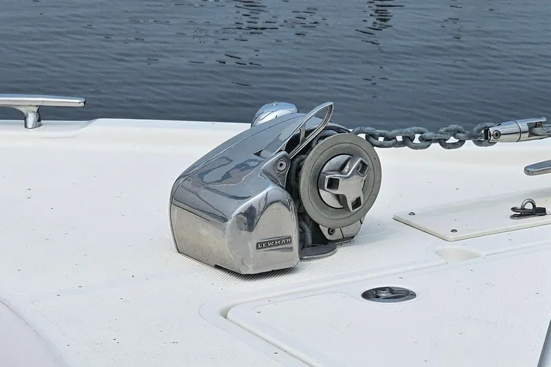 Slide: The Image of 2009 Pursuit OS 315 Offshore boat anchor winch on deck by the water. - 10