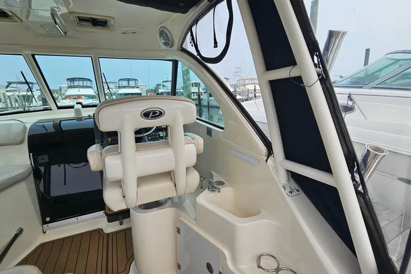 Slide: The Image of 2009 Pursuit OS 315 Offshore boat interior with helm and seating area. - 14