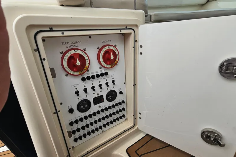 Slide: The Image of Control panel of a 2009 Pursuit OS 315 Offshore boat with switches and dials. - 16