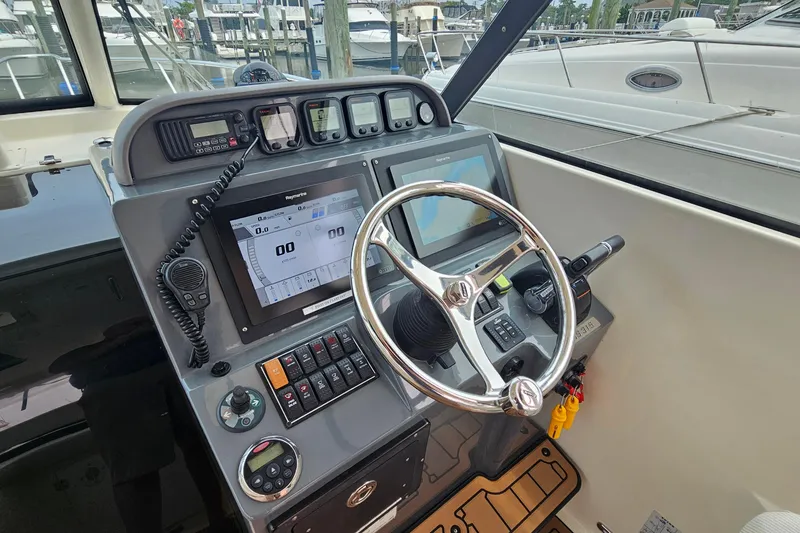 Slide: The Image of 2009 Pursuit OS 315 Offshore helm with modern navigation and control systems. - 17