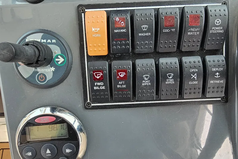 Slide: The Image of Control panel of a 2009 Pursuit OS 315 Offshore boat with various switches and gauges. - 21
