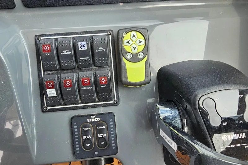 Slide: The Image of Control panel of a 2009 Pursuit OS 315 Offshore boat with switches and throttle. - 22