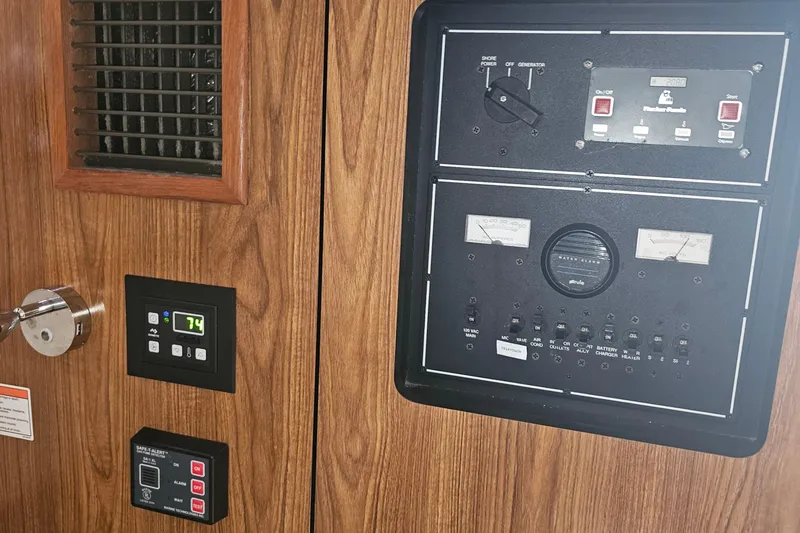 Slide: The Image of Control panel of a 2009 Pursuit OS 315 Offshore boat with wood finish. - 24