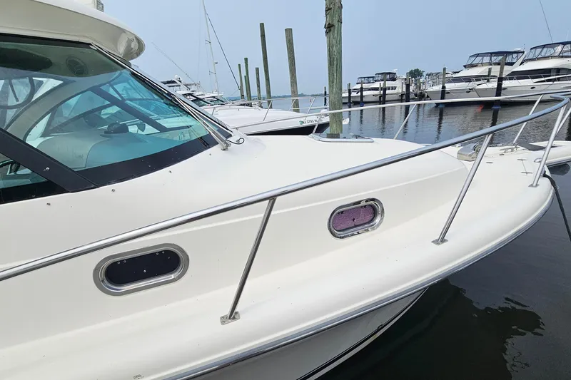 Slide: The Image of 2009 Pursuit OS 315 Offshore boat docked at marina, side view. - 8